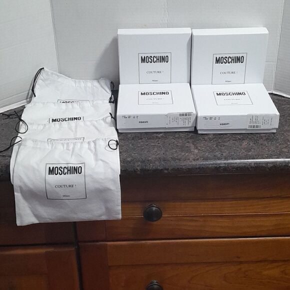 4 Moschino Deluxe Boxes, 4 Deluxe Dust Bags, and 1 and one Enclosure.